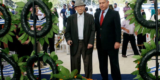 In this July 11, 2010 file photo Israeli Prime Minister Benjamin Netanyahu, right, and his father Benzion attend the official memorial service for the late Zionist leader Ze'ev Jabotinsky at the Mt. Herzl cemetery in Jerusalem.