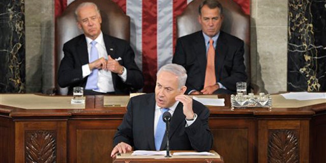 Israel's Prime Minister Benjamin Netanyahu gestures while addressing a joint meeting of Congress in Washington May 24. House Speaker John Boehner, right, and Vice President Joe Biden listen.