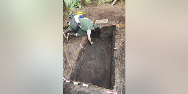 An archaeologist working at the site of the camp used by survivors of The Neva