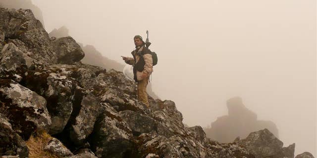 Co-author Shashank Dalvi looking for thrushes 4200 m, Sela Pass, West Kameng, India, June 2009.