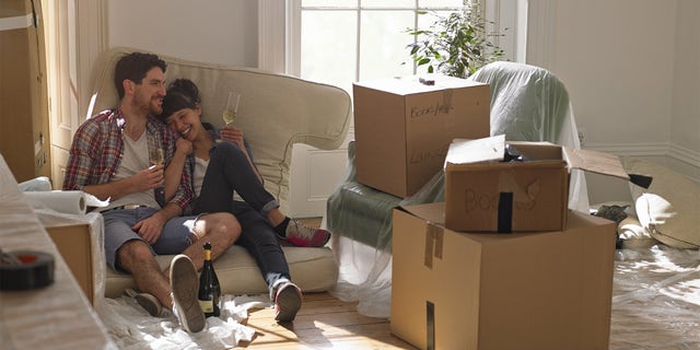 couple moving in to new house, drinking champagne