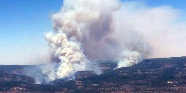June 15, 2014: This image provided by Inci Web shows a plume of smoke in the Chuska Mountains near Naschitti, N.M.