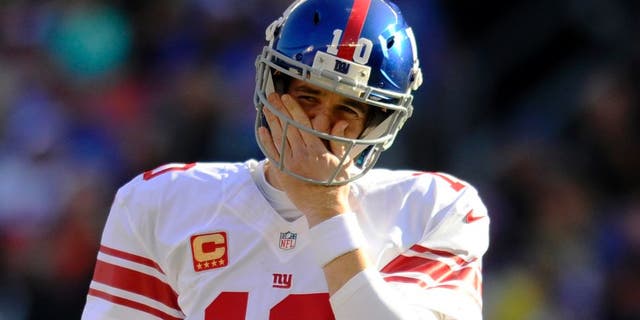 CLEVELAND, OH - NOVEMBER 27, 2016: Quarterback Eli Manning #10 of the New York Giants wipes his face as he walks onto the field during a game against the Cleveland Browns on November 27, 2016 at FirstEnergy Stadium in Cleveland, Ohio. New York won 27-13. (Photo by: Nick Cammett/Diamond Images/Getty Imges)