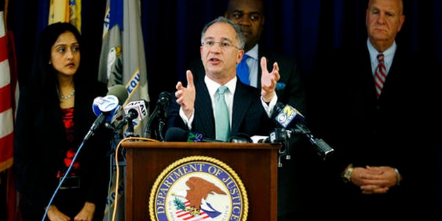 Paul Fishman, front, U.S. attorney for the District of New Jersey, stands with Vanita Gupta, left, principal deputy assistant attorney general for the U.S. Department of Justice Civil Rights Division, Newark Mayor Ras Baraka, center back, and Anthony Ambrose, right, Newark public safety director, while speaking during a news conference, Wednesday, March 30, 2016, in Newark, N.J.