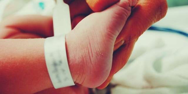 Holding My newborn Sons foot
