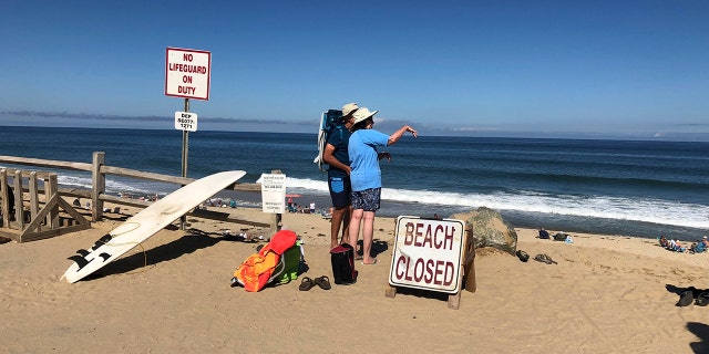 Beachgoers at Newcomb Hollow Beach were greeted by signs reading "Beach Closed" following Saturday's attack.