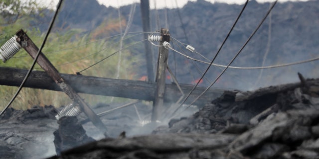 Utility poles and power lines sit destroyed in the Kilauea lava flow on Pohoiki Road near Pahoa, Hawaii, U.S., May 29, 2018.