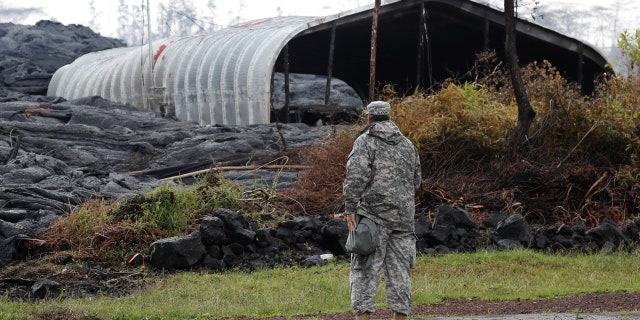 Maj. Jeff Hickman, of the Hawaii National Guard, stands near a structure destroyed by the Kilauea lava flow, in Leilani Estates near Pahoa, Hawaii, U.S., May 29, 2018.