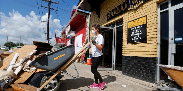 Pre-med student Sheila Tendero, from the Miami Medical Team, helps gut the Zulu Social Aid & Pleasure Club Store in New Orleans, which flooded during storms.