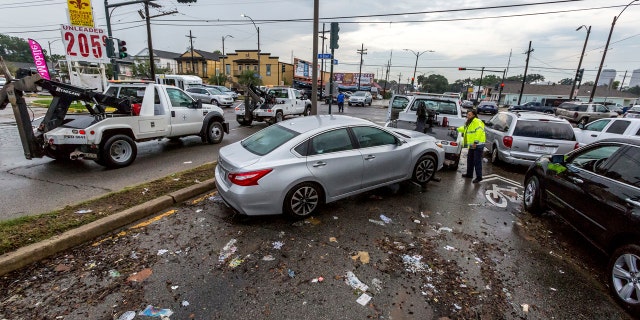 Flooded cars are cleared from Orleans Avenue at Broad Street in Mid City.