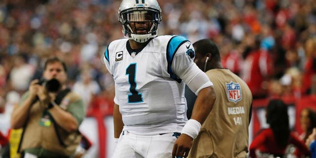 Carolina Panthers quarterback Cam Newton (1) reacts to a run against the Atlanta Falcons during the first half of an NFL football game, Sunday, Dec. 27, 2015, in Atlanta. (AP Photo/John Bazemore)
