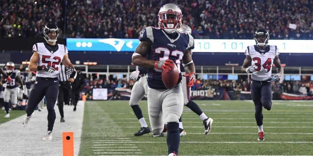 Jan 14, 2017; Foxborough, MA, USA; New England Patriots running back Dion Lewis (33)returns a kick for a touchdown against the Houston Texans during the first quarter in the AFC Divisional playoff game at Gillette Stadium. Mandatory Credit: James Lang-USA TODAY Sports