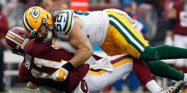 Green Bay Packers linebacker Clay Matthews (52) hits Washington Redskins quarterback Alex Smith (11) during a game.
