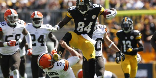 Sep 7, 2014; Pittsburgh, PA, USA; Pittsburgh Steelers wide receiver Antonio Brown (84) runs over Cleveland Browns punter Spencer Lanning (5) during the first half at Heinz Field. Brown was flagged on the play. Mandatory Credit: Jason Bridge-USA TODAY Sports