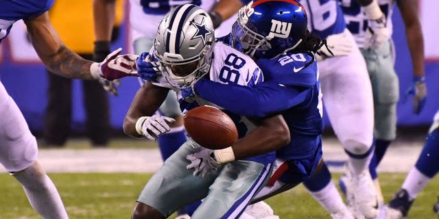 Dec 11, 2016; East Rutherford, NJ, USA; Dallas Cowboys wide receiver Dez Bryant (88) fumbles the ball late in the fourth quarter as New York Giants cornerback Janoris Jenkins (20) makes the hit at MetLife Stadium. Mandatory Credit: Robert Deutsch-USA TODAY Sports