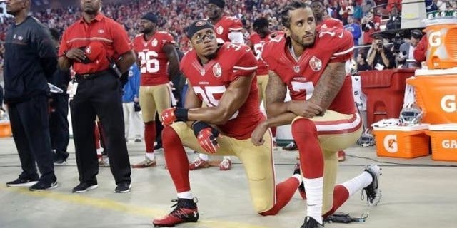 Eric Reid, left, kneeled during with the national anthem with Colin Kaepernick, right.