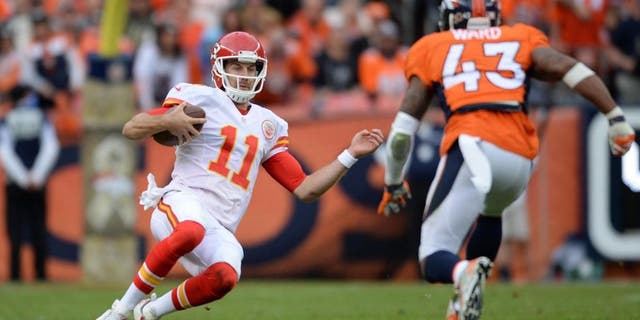 Nov 15, 2015; Denver, CO, USA; Kansas City Chiefs quarterback Alex Smith (11) slides as Denver Broncos strong safety T.J. Ward (43) closes in in the second quarter at Sports Authority Field at Mile High. Mandatory Credit: Ron Chenoy-USA TODAY Sports