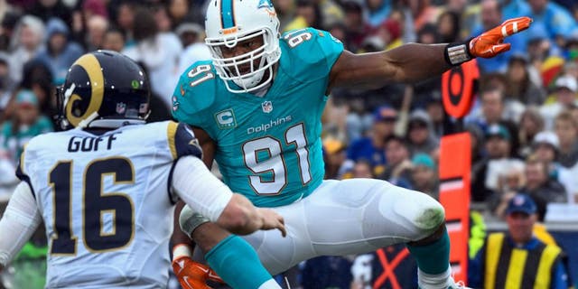 Ex-Miami Dolphins defensive end Cameron Wake (91) leaps as he pressures Los Angeles Rams quarterback Case Keenum (17) during the second quarter at Los Angeles Memorial Coliseum. (Robert Hanashiro-USA TODAY Sports)