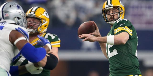 Jan 15, 2017; Arlington, TX, USA; Green Bay Packers quarterback Aaron Rodgers (12) throws a pass against the Dallas Cowboys during the first quarter in the NFC Divisional playoff game at AT&T Stadium. Mandatory Credit: Matthew Emmons-USA TODAY Sports