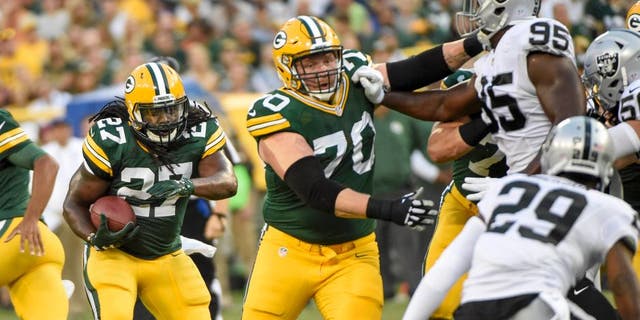 Aug 18, 2016; Green Bay, WI, USA; Green Bay Packers running back Eddie Lacy (27) follows a block by guard T.J. Lang (70) in the first quarter during the game against the Oakland Raiders at Lambeau Field. Mandatory Credit: Benny Sieu-USA TODAY Sports