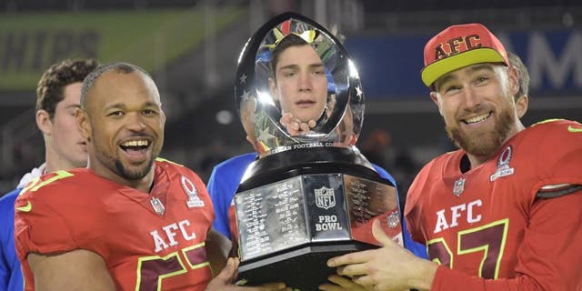 Jan 29, 2017; Orlando, FL, USA; AFC linebacker Lorenzo Alexander of the Buffalo Bills (57) and tight end Travis Kelce of the Kansas City Chiefs (87) hold the Pro Bowl trophy after the 2017 Pro Bowl at Camping World Stadium. The AFC defeated the NFC 20-13. Mandatory Credit: Kirby Lee-USA TODAY Sports