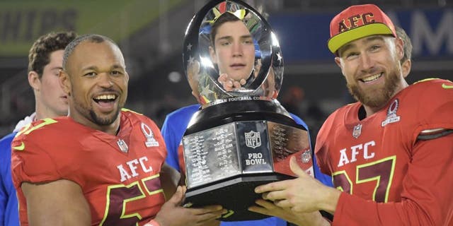 Jan 29, 2017; Orlando, FL, USA; AFC linebacker Lorenzo Alexander of the Buffalo Bills (57) and tight end Travis Kelce of the Kansas City Chiefs (87) hold the Pro Bowl trophy after the 2017 Pro Bowl at Camping World Stadium. The AFC defeated the NFC 20-13. Mandatory Credit: Kirby Lee-USA TODAY Sports