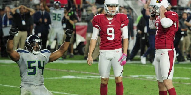 Oct 23, 2016; Glendale, AZ, USA; Arizona Cardinals kicker Chandler Catanzaro (7) reacts after missing a field goal in overtime as punter Ryan Quigley (9) and Seattle Seahawks middle linebacker Bobby Wagner (54) react at University of Phoenix Stadium. Mandatory Credit: Matt Kartozian-USA TODAY Sports