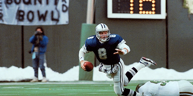 Dallas Cowboys' quarterback Troy Aikman is unable to get a pass off as he is tackled by Eagles' Reggie White during the first half of NFL game on Dec. 10, 1989 in Philadelphia. Eagles won, 20-10. (AP Photo/Brad Bower)