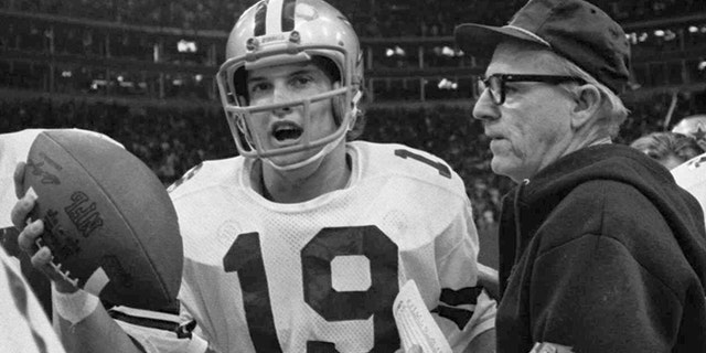 FILE - In this Nov. 28, 1974, Dallas Cowboys rookie quarterback Clint Longley walks off the field carrying the game ball after after he threw a long bomb to wide receiver Drew Pearson for a touchdown in the final seconds of their 24-23 win over the Washington Redskins in an NFL football game at Texas Stadium in Irving, Texas. Longley is dubbed "The Mad Bomber" after replacing an injured Roger Staubach and hitting Drew Pearson with a 50-yard, winning TD pass with 35 seconds left. (AP Photo/File)