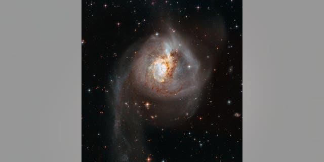 This Hubble Space Telescope image shows the peculiar galaxy NGC 3256. The galaxy is about 100 million light-years from Earth and is the result of a past galactic merger, which created its distorted appearance. As such, NGC 3256 provides an ideal target to investigate starbursts that have been triggered by galaxy mergers.