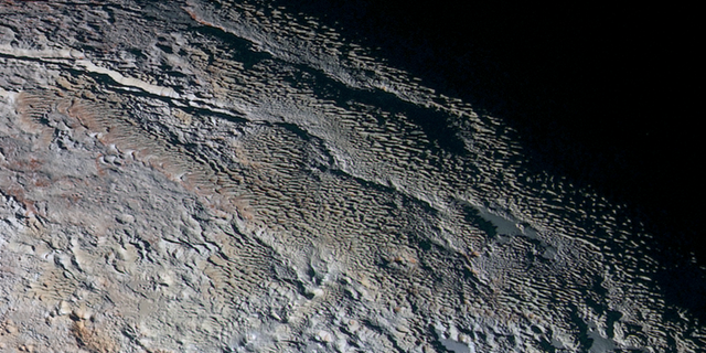 The bladed terrain of Pluto’s informally named Tartarus Dorsa region, imaged by NASA’s New Horizons spacecraft in July 2015. (Credits: NASA/JHUAPL/SwRI)