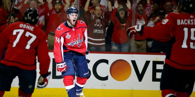Washington Capitals defenseman John Carlson, center, celebrates with teammates after scoring a goal against the Vegas Golden Knights during the second period in Game 4 of the NHL hockey Stanley Cup Final.