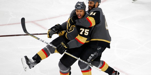 Vegas Golden Knights right wing Ryan Reaves, left, celebrates his goal with left wing Pierre-Edouard Bellemare, of France, during the third period in Game 1 of the NHL hockey Stanley Cup Finals against the Washington Capitals Monday, May 28, 2018, in Las Vegas.