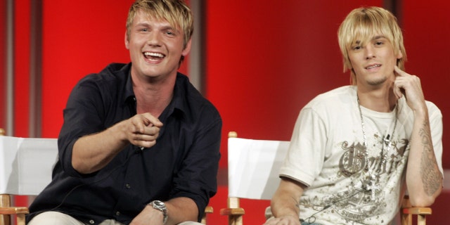 Singers and brothers Nick (L) and Aaron Carter answer questions about their new reality television program 'House of Carters' which features them and their three sisters on E! Networks during a session at a Cable Television Critics Association press tour in Pasadena, California July 11, 2006. The series will premiere in October 2006. REUTERS/Fred Prouser (UNITED STATES) - RTR1FEQR