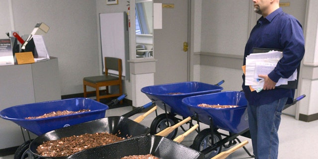 Nick Stafford waits on line at local DMV with five wheelbarrows full of pennies. (David Crigger/Bristol Herald Courier)