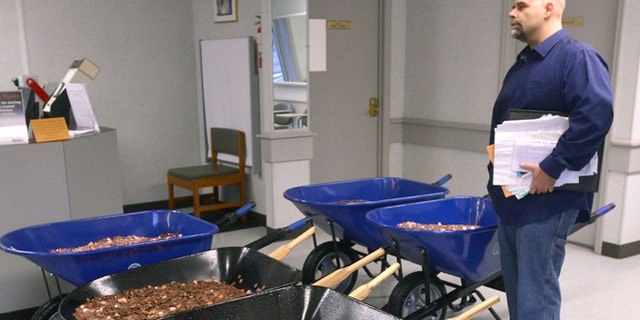 Nick Stafford waits on line at local DMV with five wheelbarrows full of pennies. (David Crigger/Bristol Herald Courier)