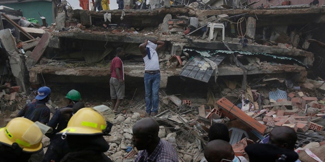 Rescue workers search for survivors at the rubbles of a collapsed building in a densely populated neighborhood in Lagos, Nigeria. Tuesday, July 25, 2017. Rescue work is still ongoing. (AP Photo/Sunday Alamba)