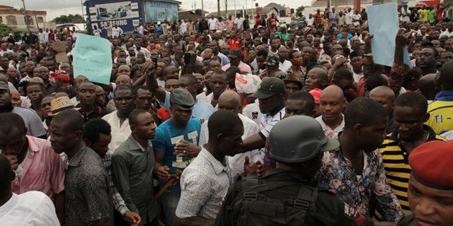 March 29, 2015: Security forces hold back protesters against the recent election in Port Harcourt , Nigeria.