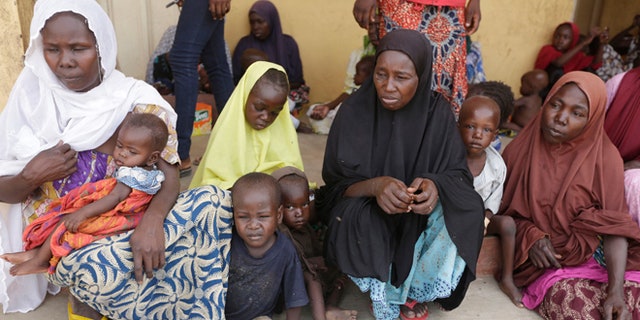 Women and children rescued by Nigerian soldiers from Boko Haram extremists at Sambisa Forest wait for treatment at a refugee camp in Yola, Nigeria. Boko Haram fighters stoned captives to death, some girls and women were crushed by an armored car and three died when a land mine exploded as they walked to freedom.  (AP Photo/Sunday Alamba)