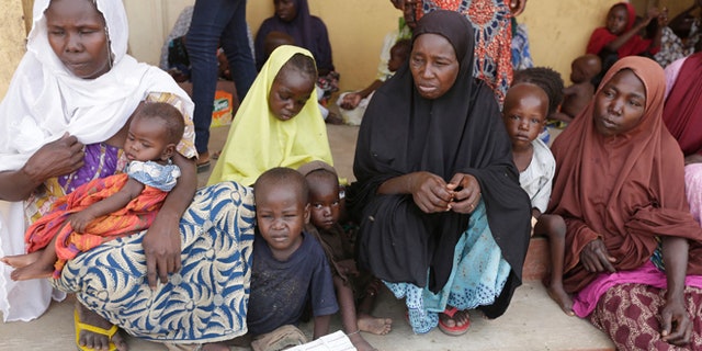 Women and children rescued by Nigerian soldiers from Boko Haram extremists at Sambisa Forest wait for treatment at a refugee camp in Yola, Nigeria. Boko Haram fighters stoned captives to death, some girls and women were crushed by an armored car and three died when a land mine exploded as they walked to freedom. (AP Photo/Sunday Alamba)
