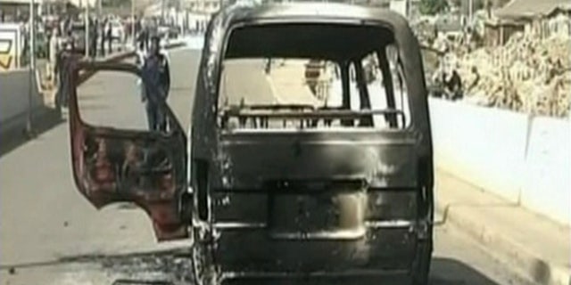 Dec. 25: In this image made from video provided NTA via APTN, a burned out van is seen on a road following violence in Jos, Nigeria. Dozens of people were killed over the holiday weekend in attacks across Nigeria, including 32 that died in central Nigeria in a series of bomb blasts in the worst violence to hit the region in months. (AP)