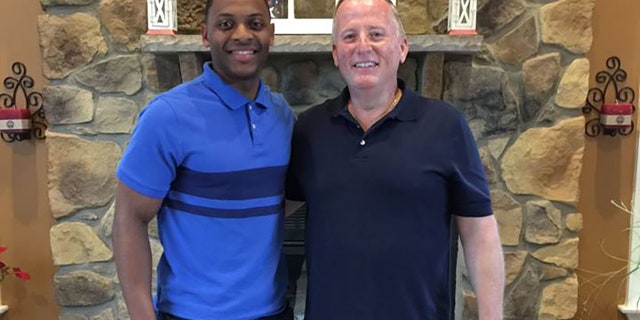 Trooper Michael Patterson (left) standing with retired police officer Matthew Baily (right) at a reunion following the traffic stop.