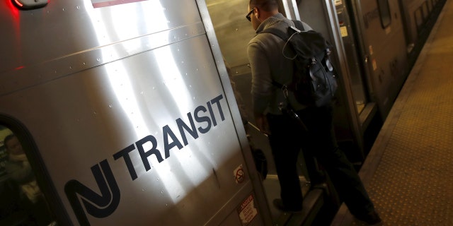 A commuter boards a New Jersey Transit commuter train bound for New York City at a station in Secaucus, N.J., March 10, 2016.
