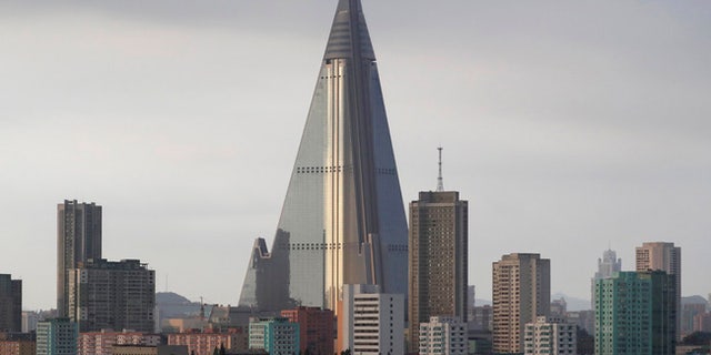 The 105-story Ryugyong hotel towers over residential buildings in Pyongyang, North Korea.