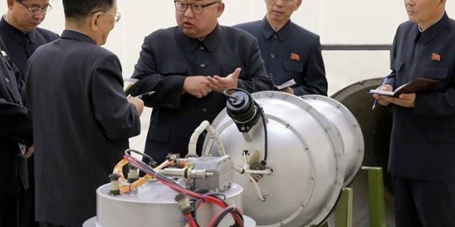 Kim Jong Un was pictured in September with what appeared to be a nuclear device after the Hermit Kingdom's sixth nuclear test.