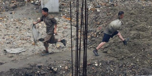 Labourers work at a construction site in Pyongyang.