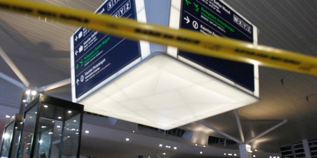 Tape blocks the entrance to the main hall of Kuala Lumpur International Airport 2 for the decontamination process in Sepang, Malaysia on Sunday, Feb. 26, 2017. Malaysian police ordered a sweep of Kuala Lumpur airport for toxic chemicals and other hazardous substances following the killing of Kim Jong Nam. (AP Photo/Daniel Chan)