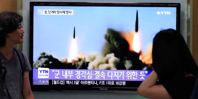 June 26, 2014: People watch a TV news program showing the missile launch conducted by North Korea, at Seoul Railway Station in Seoul, South Korea. (AP)