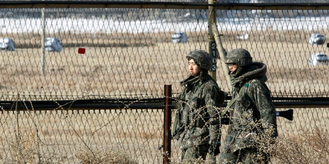 Jan. 27, 2013: South Korean army soldiers patrol along a barbed-wire fence in Paju, South Korea, near the demilitarized zone (DMZ) of Panmunjom.