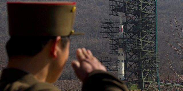 April 8, 2012: In this file photo, a North Korean soldier salutes in front of the country's Unha-3 rocket at Sohae Satellite Station in Tongchang-ri, North Korea.
